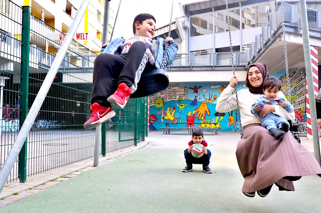 Honorarkraft Arzu mit Kindern auf dem Spielplatz Neues Kreuzberger Zentrum. Foto: Andrei Schnell
